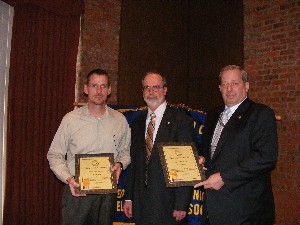 Strimpler (c) recognizes new life members Stephen C. Gona (l), information technology specialist, U.S. Army Communications-Electronics Command Life Cycle Management Command, and Gary J. Gnidzeijkp, director of information management, Picatinny, during the March meeting.